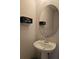 Cozy bathroom featuring a pedestal sink, oval mirror, and 