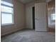 Bright bedroom with closet, window, and neutral carpet for a warm and inviting space at 19643 Shady Oak Dr, Land O Lakes, FL 34638