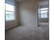 Bright bedroom with plush carpet, and a door leading to another room, providing a comfortable living space at 19643 Shady Oak Dr, Land O Lakes, FL 34638