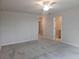 Large bedroom with neutral carpet and access to bathroom and walk-in closet at 19643 Shady Oak Dr, Land O Lakes, FL 34638