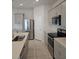 Well-equipped kitchen with stainless steel refrigerator, sleek microwave, and white backsplash at 19643 Shady Oak Dr, Land O Lakes, FL 34638