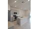 Modern kitchen featuring stainless steel appliances, a center island, and tile flooring at 19643 Shady Oak Dr, Land O Lakes, FL 34638