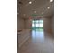 Open living space with tile flooring, recessed lighting, and sliding glass doors to the backyard at 19643 Shady Oak Dr, Land O Lakes, FL 34638