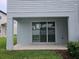 Covered patio features a sliding glass door and views of the backyard and neighborhood at 19643 Shady Oak Dr, Land O Lakes, FL 34638