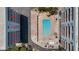 Aerial view of pool and amenities, nestled between beachfront condo buildings at 19925 Gulf Blvd # 407, Indian Shores, FL 33785