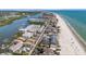 Beautiful aerial view of beachfront condos with pristine white sand, gorgeous blue waters, and coastal living at 19925 Gulf Blvd # 407, Indian Shores, FL 33785