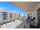 Balcony with seating area overlooking the pool at 19925 Gulf Blvd # 407, Indian Shores, FL 33785