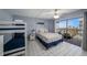Light-filled bedroom with bunk beds, a king-sized bed and sliding doors leading to a balcony with outdoor seating at 19925 Gulf Blvd # 407, Indian Shores, FL 33785
