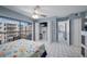 Bright bedroom with tiled floors, spacious closets, and balcony access offering an abundance of natural light at 19925 Gulf Blvd # 407, Indian Shores, FL 33785