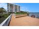 Exterior shot showing dock with bench seating in front of a condo building, all next to the water at 19925 Gulf Blvd # 407, Indian Shores, FL 33785