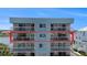 Modern condo building with multiple floors and private balconies overlooking the water at 19925 Gulf Blvd # 407, Indian Shores, FL 33785