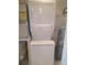 Efficient laundry room with stacked washer and dryer unit, maximizing space, plus hot water heater and vacuum at 19925 Gulf Blvd # 407, Indian Shores, FL 33785