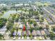 Aerial view showcasing a quiet residential neighborhood with tree-lined streets and a nearby lake at 2024 Glen Forge St, Brandon, FL 33511