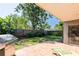 Outdoor patio area includes a grill, lounge chair, and lush tropical landscaping at 2024 Glen Forge St, Brandon, FL 33511