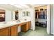 Bright bathroom featuring a double sink vanity and a large walk-in closet with ample storage at 2024 Glen Forge St, Brandon, FL 33511