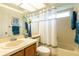 Bathroom with a shower-tub combination, a stylish shower curtain, and matching blue towels at 2024 Glen Forge St, Brandon, FL 33511