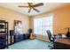 Comfortable bedroom with a ceiling fan, large window, and a setup for working or hobbies at 2024 Glen Forge St, Brandon, FL 33511