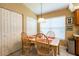 The Dining Area is illuminated by natural light with a table set for four, next to the Kitchen at 2024 Glen Forge St, Brandon, FL 33511
