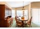 Formal dining room with a bay window, a round table with four chairs, and a wooden hutch at 2024 Glen Forge St, Brandon, FL 33511