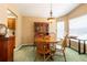 Formal dining room with hardwood furniture, including a round table and a wooden hutch, next to the kitchen at 2024 Glen Forge St, Brandon, FL 33511