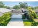 Charming single-Gathering home featuring a well-maintained lawn, mature landscaping, and a two-car garage at 2024 Glen Forge St, Brandon, FL 33511
