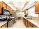 Bright kitchen featuring wooden cabinetry, stainless steel appliances, and tile flooring at 2024 Glen Forge St, Brandon, FL 33511