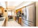 Well-lit kitchen showcasing stainless steel appliances, tile flooring, and a view into the dining area at 2024 Glen Forge St, Brandon, FL 33511