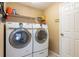 Laundry room equipped with modern washer and dryer units, plus shelving for storage solutions at 2024 Glen Forge St, Brandon, FL 33511