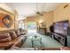 Living room showcasing a fireplace, leather sofas, and sliding glass doors to the backyard at 2024 Glen Forge St, Brandon, FL 33511