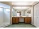 Main bathroom with a double vanity, a large mirror, and a glass-enclosed shower, next to the Main Bedroom at 2024 Glen Forge St, Brandon, FL 33511