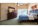 Inviting main bedroom featuring a king-sized bed, dark wood furnishings, and access to the backyard at 2024 Glen Forge St, Brandon, FL 33511