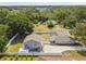 Wide aerial shot showcases the home's layout with a large fenced yard, pool, patio, and ample parking at 205 W 122Nd Ave, Tampa, FL 33612
