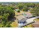Aerial view features the house and guest house, a large fenced yard, pool, and an expansive driveway at 205 W 122Nd Ave, Tampa, FL 33612