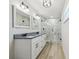 Bathroom featuring a double vanity, walk-in shower, and modern lighting at 205 W 122Nd Ave, Tampa, FL 33612