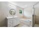 Bright bathroom with double vanity, soaking tub, and glass-enclosed shower at 205 W 122Nd Ave, Tampa, FL 33612