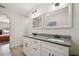 Bathroom featuring a double vanity with granite countertops and modern fixtures at 205 W 122Nd Ave, Tampa, FL 33612