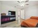 Bedroom with ceiling fan, new flooring, and closet storage at 205 W 122Nd Ave, Tampa, FL 33612