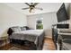 Bedroom with wood-look floors, modern ceiling fan, and good natural light at 205 W 122Nd Ave, Tampa, FL 33612