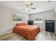 Comfortable bedroom with a ceiling fan, wood-look floors, and two windows at 205 W 122Nd Ave, Tampa, FL 33612