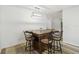 Dining area featuring modern chandelier and custom wood table with seating for four at 205 W 122Nd Ave, Tampa, FL 33612