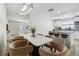Open-concept dining area adjacent to the kitchen, featuring barstool seating and modern light fixture at 205 W 122Nd Ave, Tampa, FL 33612