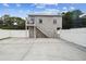 Back exterior view of the building with staircase and white privacy fence at 205 W 122Nd Ave, Tampa, FL 33612