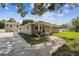 Charming single story home featuring a covered front porch and well-manicured lawn at 205 W 122Nd Ave, Tampa, FL 33612