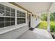Covered front porch with ample light and an inviting entryway at 205 W 122Nd Ave, Tampa, FL 33612