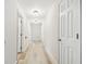 Neutral hallway with new flooring and access to various rooms in the home at 205 W 122Nd Ave, Tampa, FL 33612