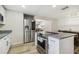 Bright kitchen with stainless steel appliances, granite countertops, and white cabinetry at 205 W 122Nd Ave, Tampa, FL 33612