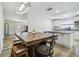 Eat-in kitchen with granite countertops, a large island, and modern light fixture at 205 W 122Nd Ave, Tampa, FL 33612