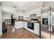 Open kitchen features bright cabinetry and appliances with a breakfast bar at 205 W 122Nd Ave, Tampa, FL 33612