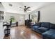Cozy living room with wood floors, ceiling fan, and natural light at 205 W 122Nd Ave, Tampa, FL 33612
