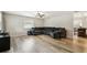 Comfortable living room with new flooring and a large sectional sofa at 205 W 122Nd Ave, Tampa, FL 33612